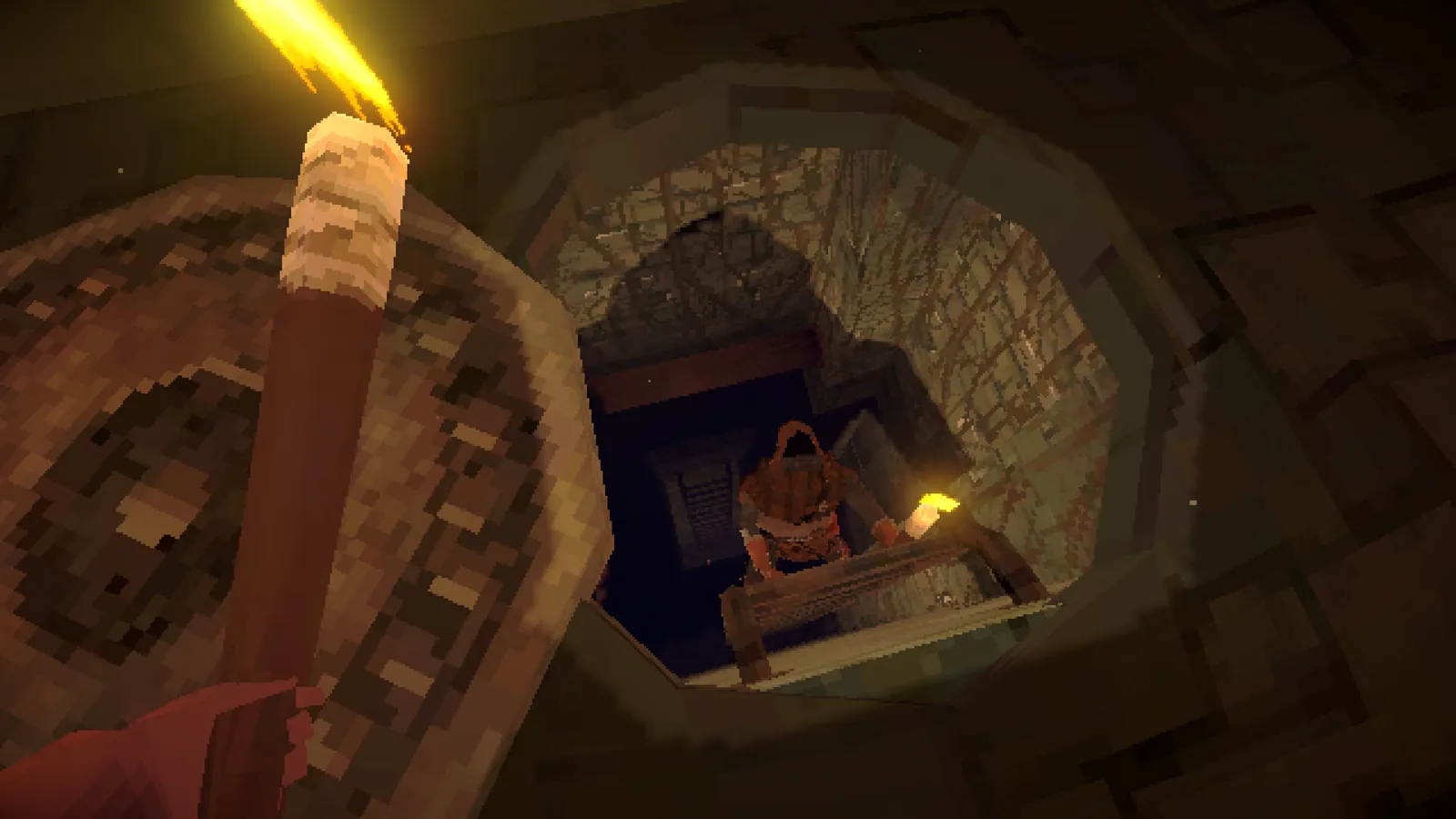 Holding a torch over a stone well with a hidden chest inside