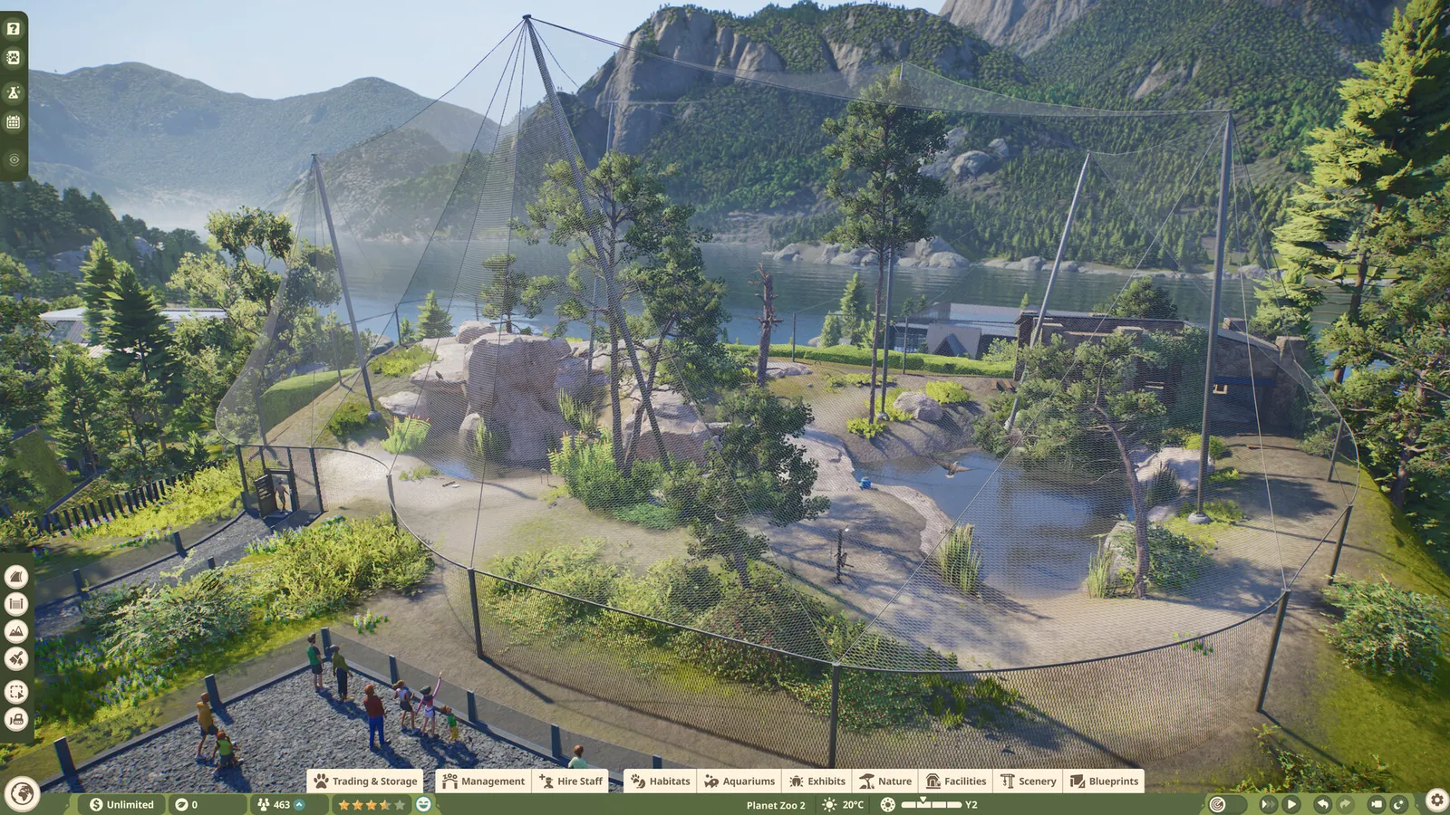A large mesh-covered aviary built into a valley