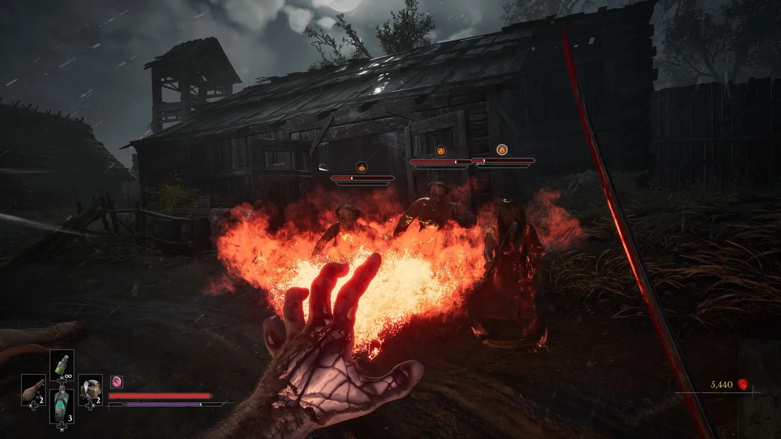 A gauntleted hand casting a burst of flame at enemies outside a wooden barn